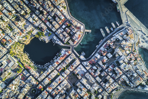Aerial view of streets, buildings and Voulismeni Lake in Agios Nikolaos Crete, Greece. Top view
