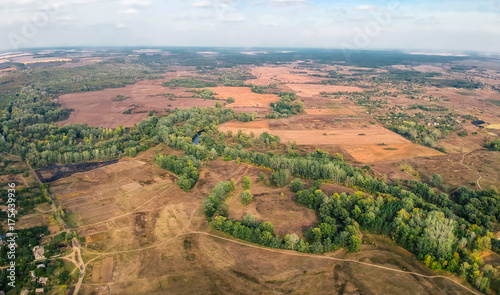 Aerial view on settlement in Eastern Europe in early autumn. Old style color grading.