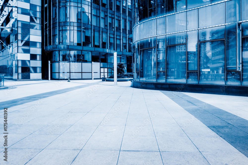 empty brick floor front of modern building, blue tone. empty brick floor front of modern building, blue tone.