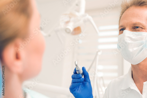 Close up of male dentist treating teeth of female patient