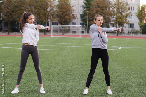 girls perform physical exercises in the open air