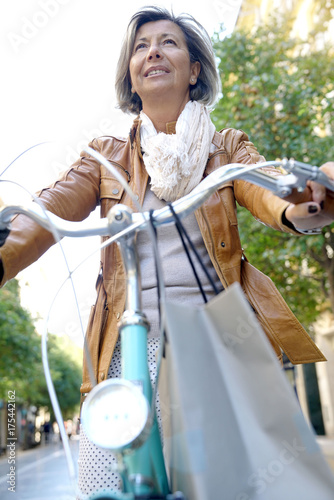 Portrait of senior woman riding city bike