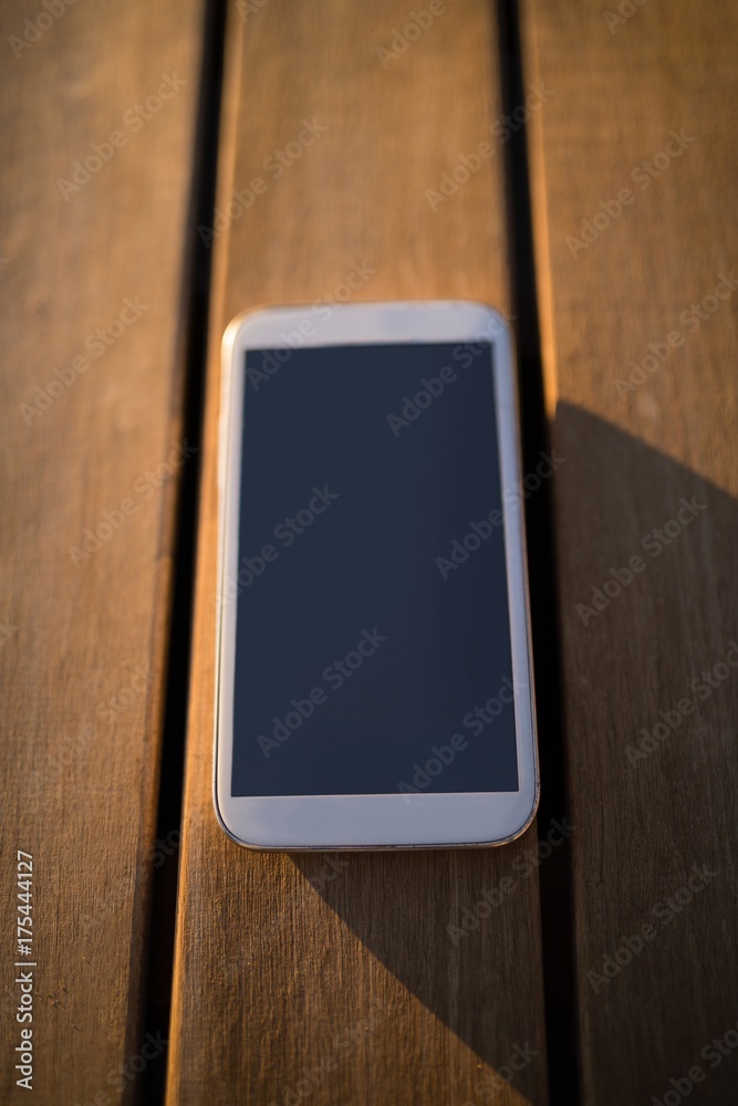 Mobile phone on wooden plank Mobile phone on wooden plank