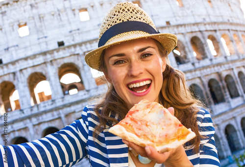 Photography tourist woman in Rome, Italy with pizza slice taking selfie