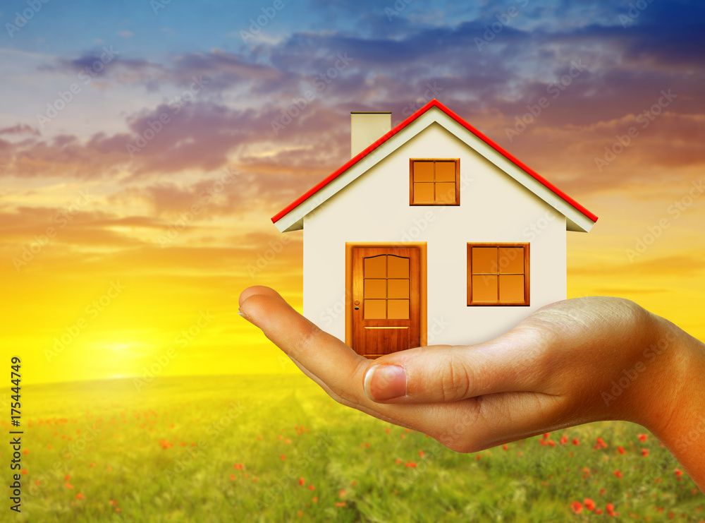 Hand holding small house at sunset. Real estate and property concept. Hand holding small house at sunset. Real estate and property concept.