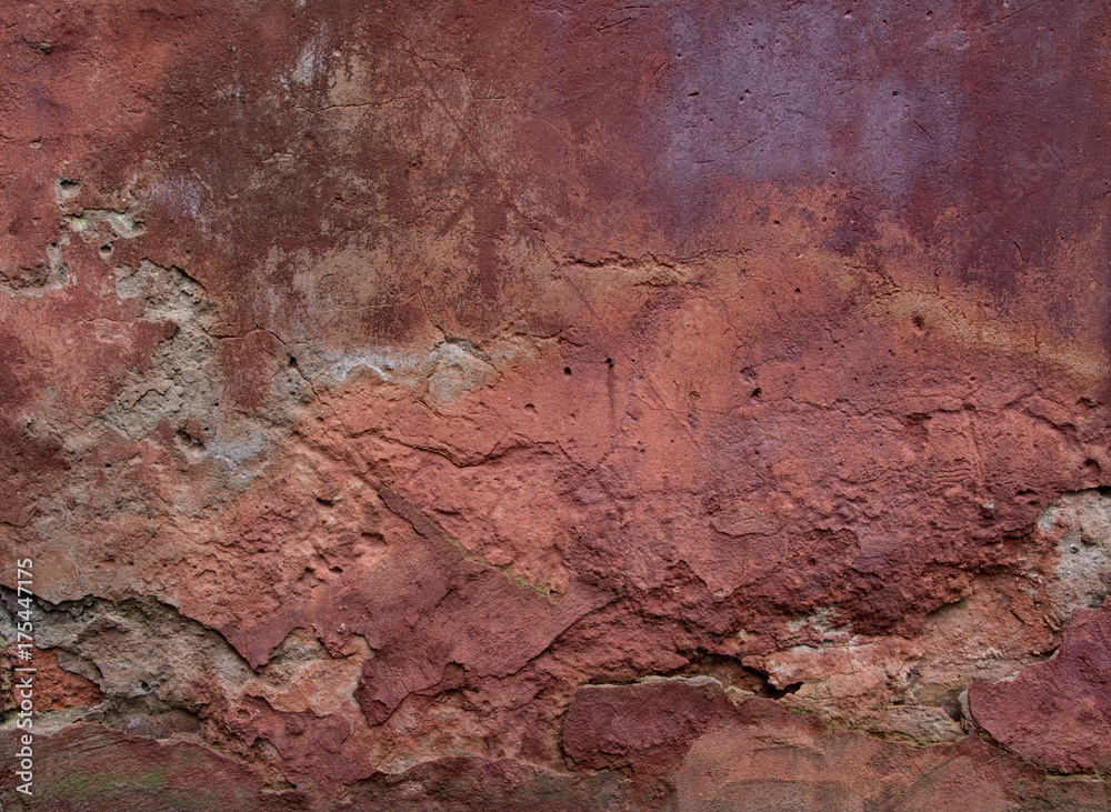 Fototapeta premium Old red wall with broken plaster. Grunge background