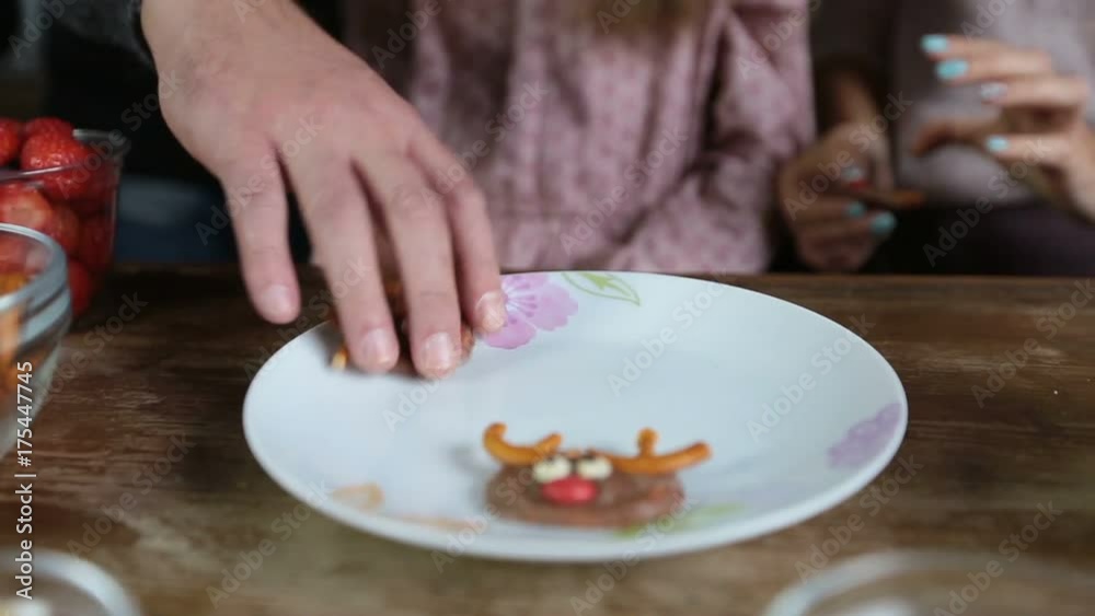 Many hands taking homemade sweets from the plate