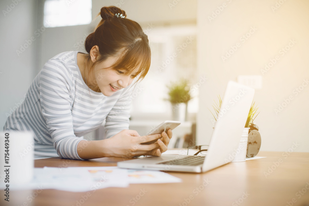 Asia businesswoman entrepreneur using smart phone from home office space Asia businesswoman entrepreneur using smart phone from home office space