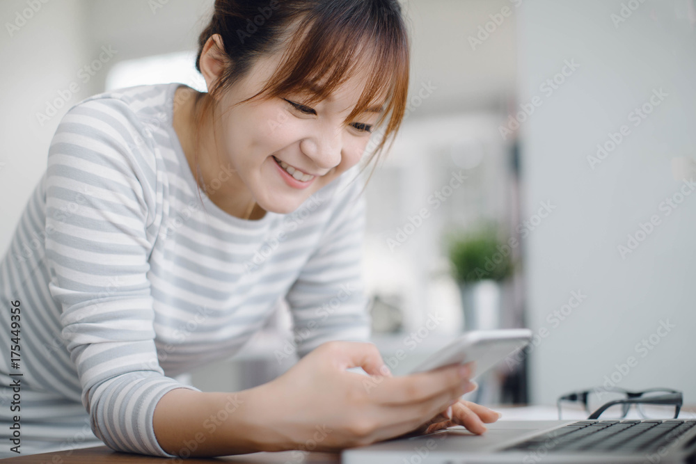 Asia businesswoman entrepreneur using smart phone from home office space Asia businesswoman entrepreneur using smart phone from home office space