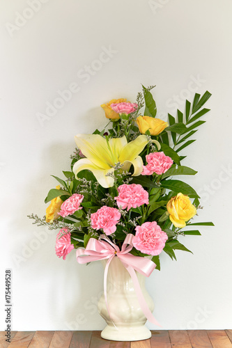 Bouquet of flowers in vase on wooden table