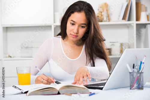 Young woman writing in notebook