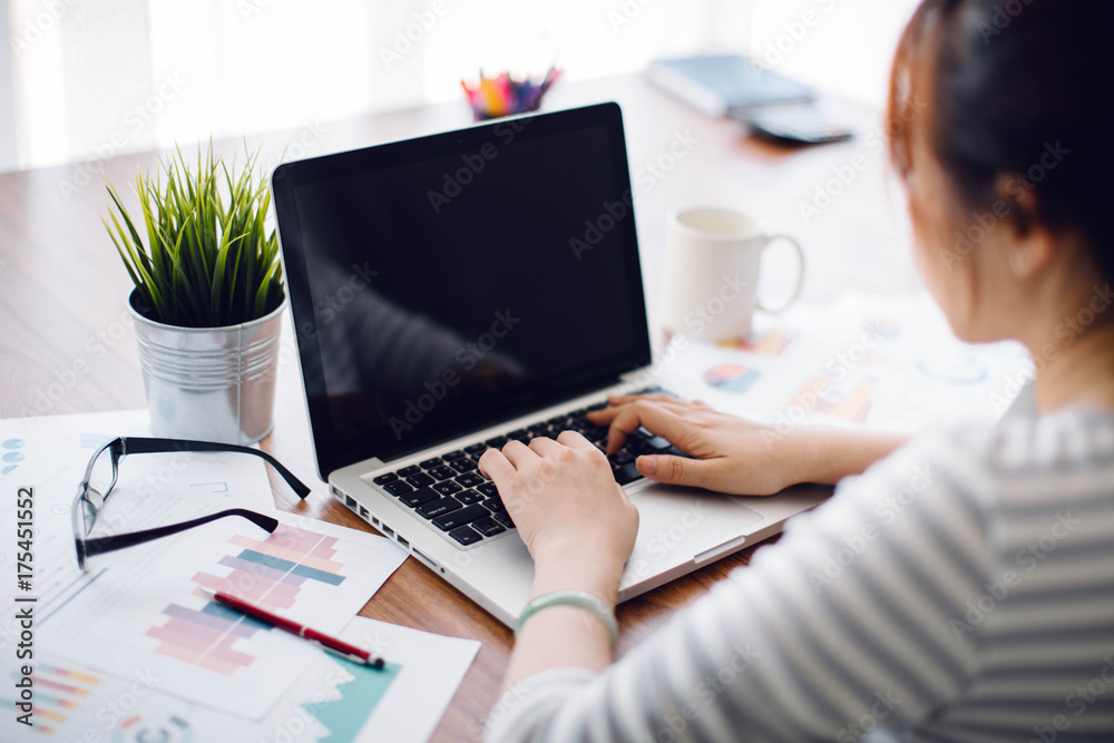 Fototapeta premium Beautiful young Asia woman working with laptop at home