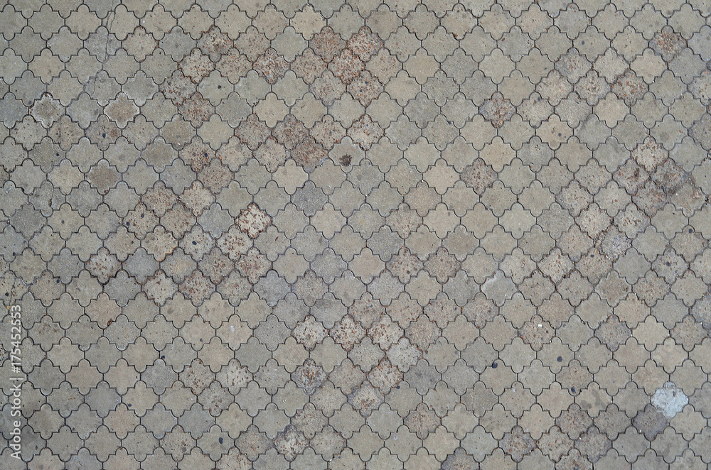 The texture of a rhythmic mosaic made of concrete tiles. Background image of a large area of old and damaged gray tiles - obrazy, fototapety, plakaty 