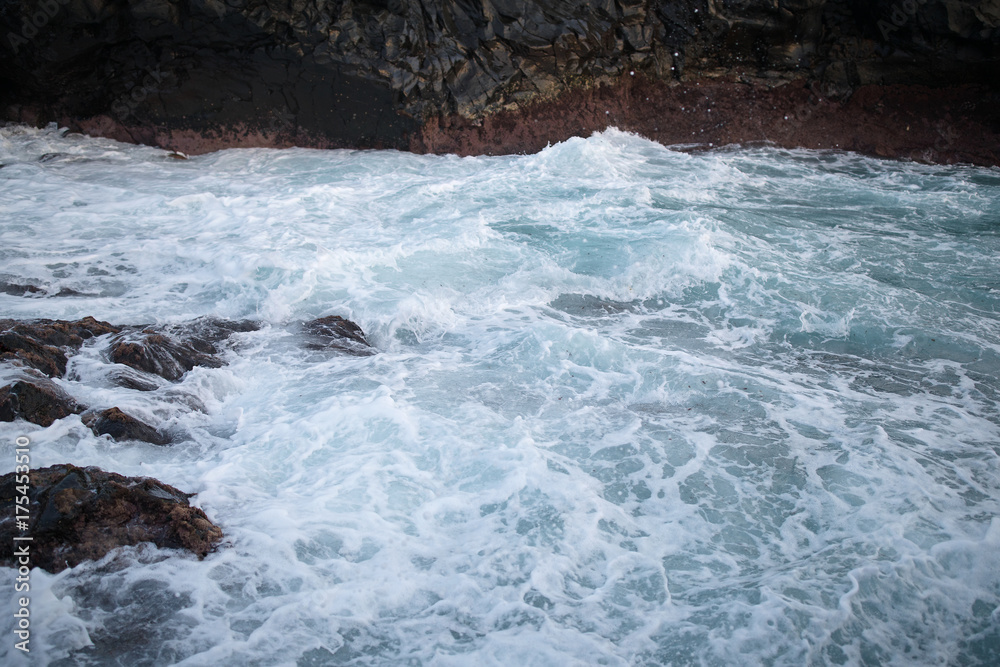 View of sea waves hitting rocks on the seashore View of sea waves hitting rocks on the seashore