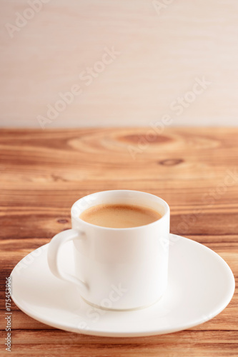 espresso cup of coffee on wood table. Vertical composition. Vintage toned.