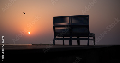 Bench chair on sunset beach