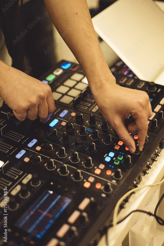 Close-up hands of soundman working with audio mixing board. Close-up hands of soundman working with audio mixing board.