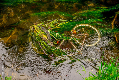 A sunken bicycle in shallow waters of river Don in Seaton park, Aberdeen, Scotland photo