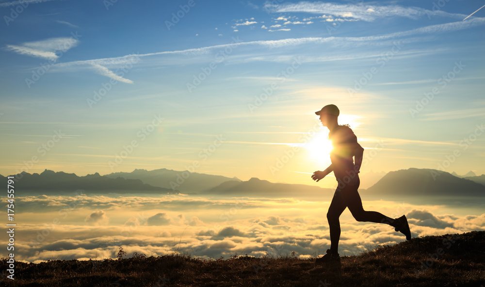 Fototapeta premium Athlete trailrunning in the mountains during a nice sunrise.