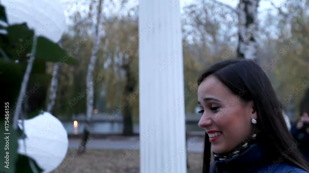 happy and embarrassed girl goes on a romantic date. an explanation of love in the park. enamored girl is walking along the bridge in the park happy and embarrassed girl goes on a romantic date. an explanation of love in the park. enamored girl is walking along the bridge in the park