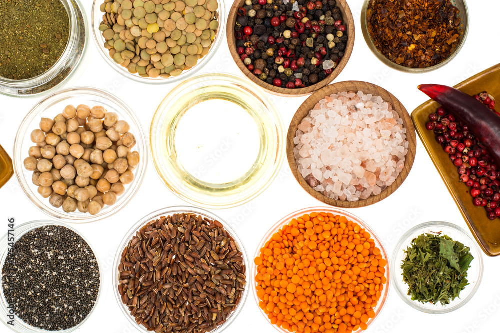 Different  bowls with spices, cereals and herbs on white background