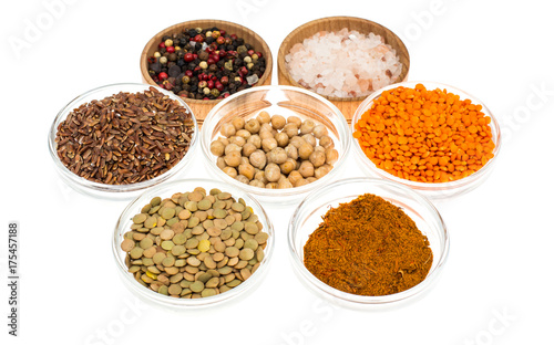 Different  bowls with spices, cereals and herbs on white background