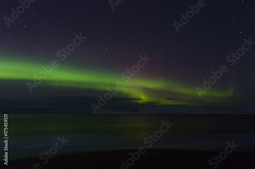 Aurora Borealis  Northern Lights  above coastal sea