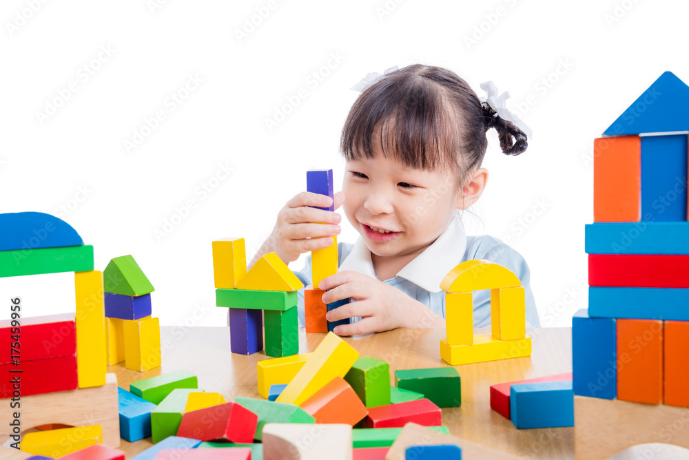 Little asian kinderkarten girl playing colorful wood block over white background Little asian kinderkarten girl playing colorful wood block over white background