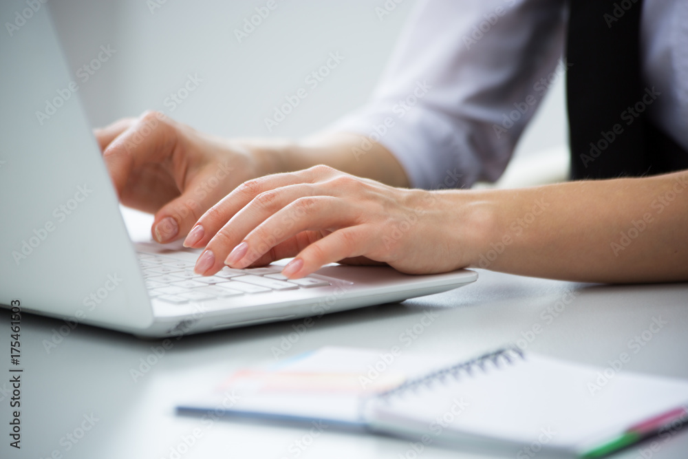 Businesswoman typing on a laptop. Businesswoman typing on a laptop.