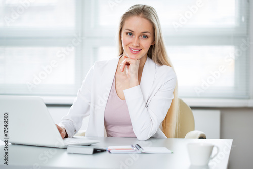 Young business woman using laptop at office