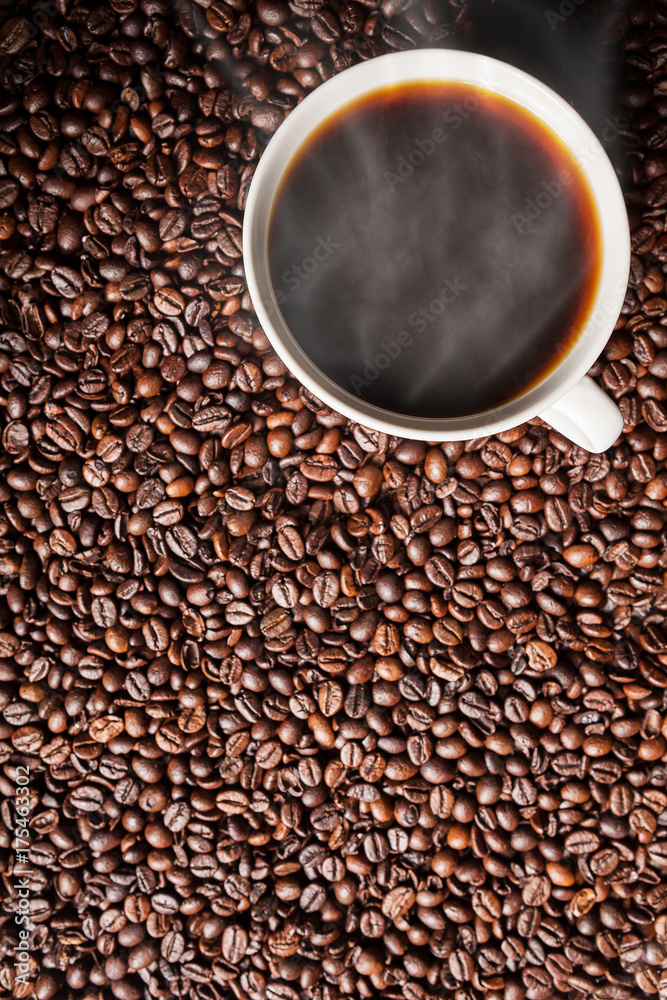Coffee cup on coffee beans in close up photo. Refreshing beverage in the morning Coffee cup on coffee beans in close up photo. Refreshing beverage in the morning