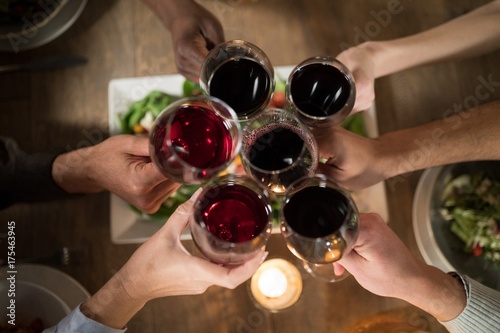 Friends toasting red wine in restaurant