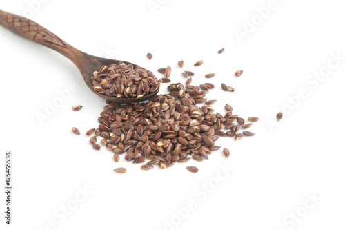 Flax seeds on wooden spoon on white background