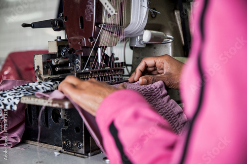 Seamstress working on industrial smocking sewing machine in factory, Cape Town, South Africa photo