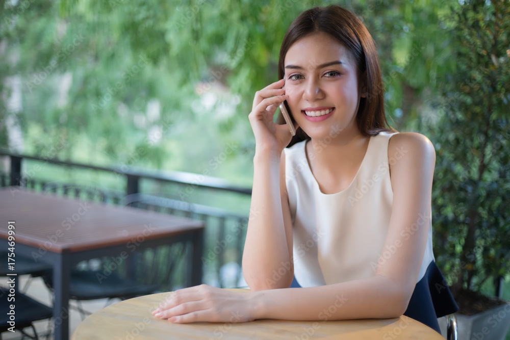 Asia Businessmen and women are using mobile and touch smart phone for Communication and checking on business people in office background Asia Businessmen and women are using mobile and touch smart phone for Communication and checking on business people in office background
