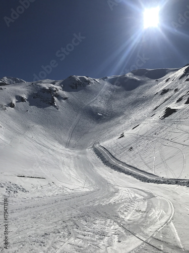 Beautiful black ski run slope Joue the Loup blue sky with sun photo