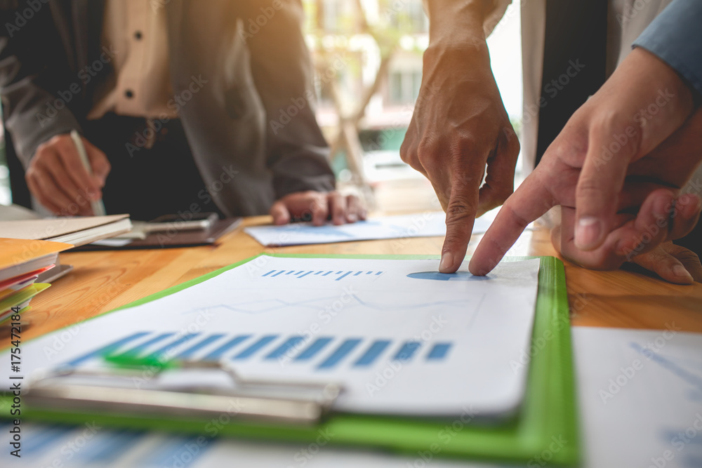 Business people meeting at working with financial reports Business people meeting at working with financial reports