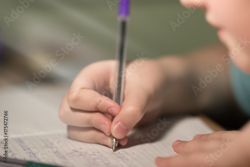 people, learning, education and school concept - close up of girl's hands writing math in notebook