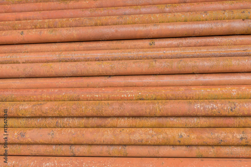 rusty metal tubes and pipes for construction and industrial use laying on heap rusty metal tubes and pipes for construction and industrial use laying on heap