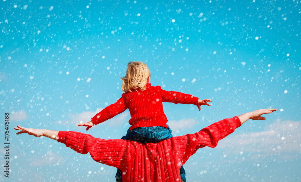 father and little daughter play at winter sky father and little daughter play at winter sky