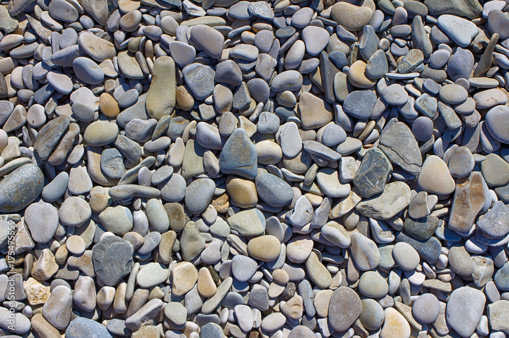 Sea pebbles. Small stones gravel texture background.The pile of pebbles, Noumea.The color of the stone in the background. Sea pebbles. Small stones gravel texture background.The pile of pebbles, Noumea.The color of the stone in the background.