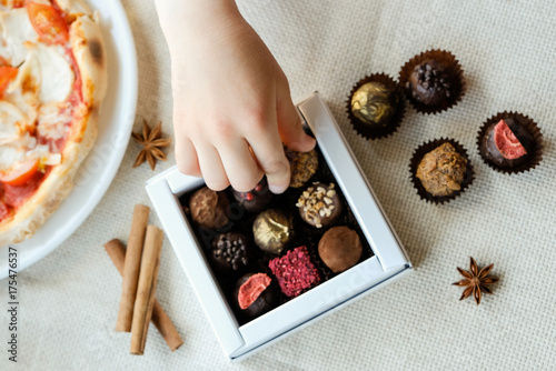 Child's hand take a sweet