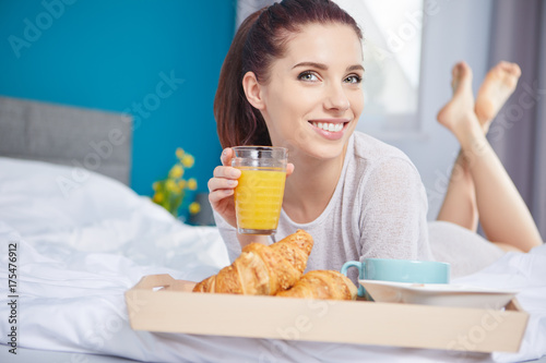 healthy cornflakes breakfast in bed woman eating and happy