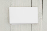 Stack of blank white index cards on weathered wood