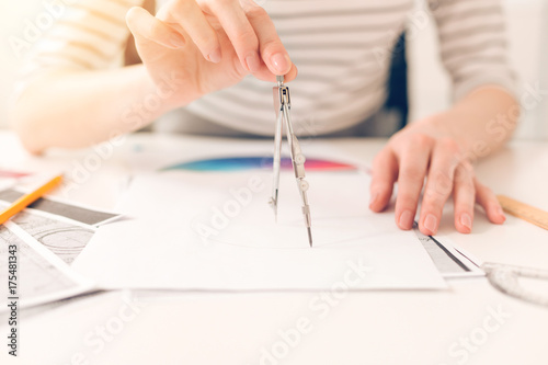 Pair of compasses being used for a drawing