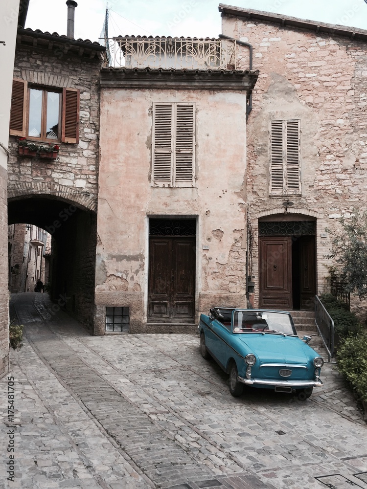 A blue old vintage car in Spello (Umbria, Italy)