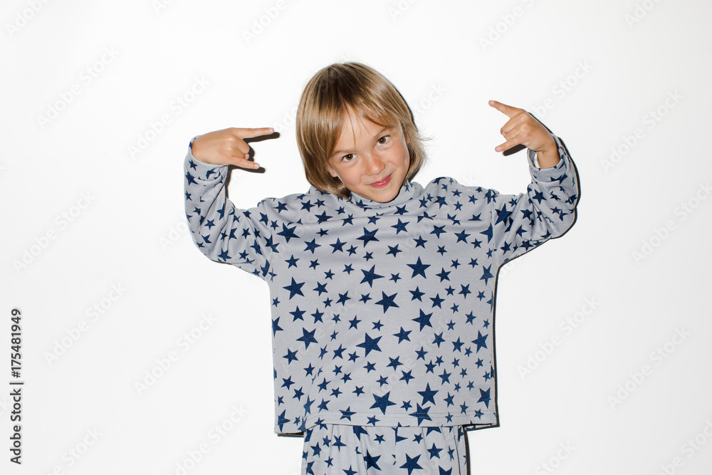 Cute boy gesturing rock at camera Cute boy gesturing rock at camera