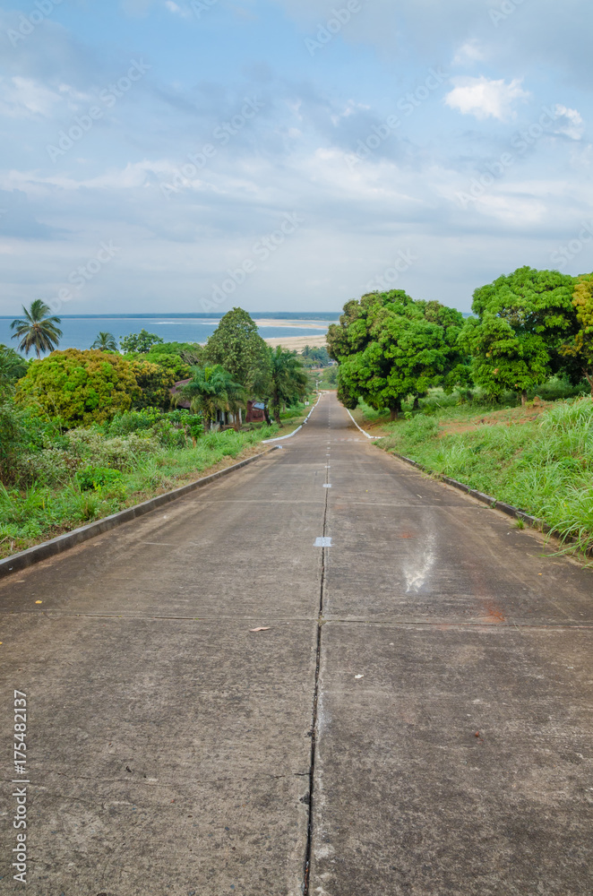 Concrete road leading down to the ocean in Robertsport, Liberia, West Africa