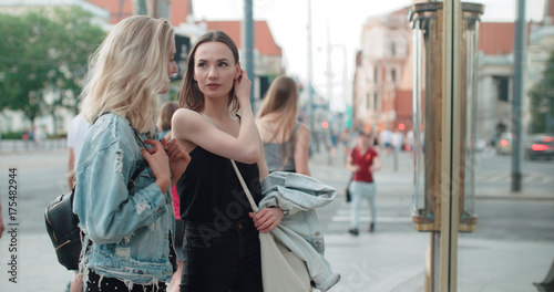 Two beautiful girls looking at clothes in a shop window. Teenage girls shopping together in a city.  © therabbithole