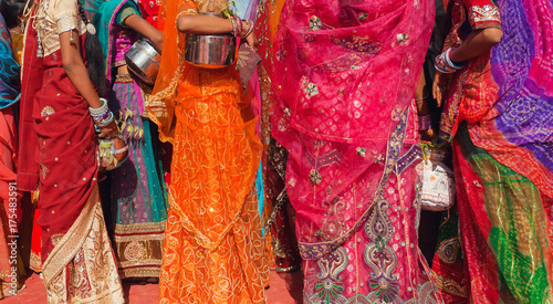 Fotografie Beautiful crowd of colorfu women dressed traditional indian sari with patterns g